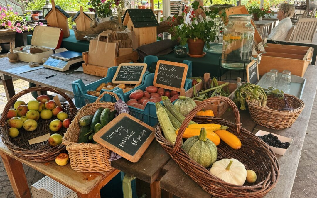 A table with baskets of fruit and vegetables on it