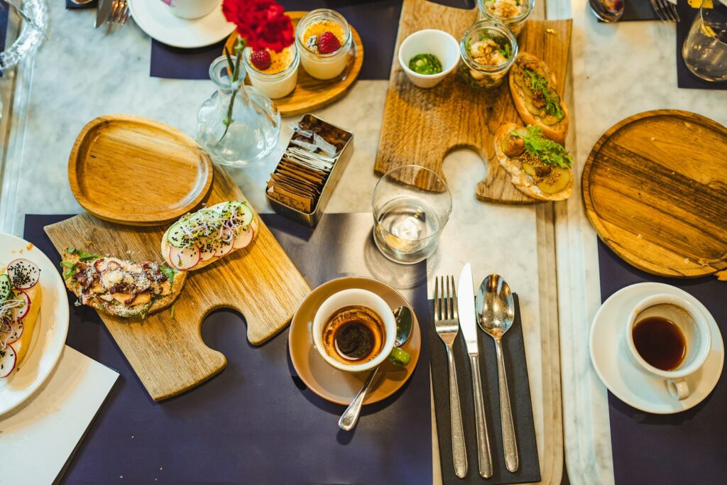 a table topped with plates of food and cups of coffee